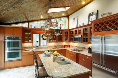 Large elegant l-shaped porcelain tile eat-in kitchen photo in Other with a double-bowl sink, glass-front cabinets, medium tone wood cabinets, granite countertops, beige backsplash, subway tile backsplash, stainless steel appliances and an island