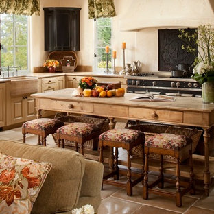 Large mediterranean open concept kitchen remodeling - Large tuscan u-shaped ceramic tile open concept kitchen photo in Other with a farmhouse sink, raised-panel cabinets, light wood cabinets, wood countertops, white backsplash, cement tile backsplash, stainless steel appliances and an island