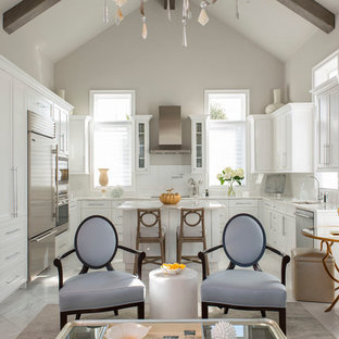 Inspiration for a transitional kitchen in Dallas with a single-bowl sink, white cabinets, marble benchtops, white splashback, stainless steel appliances, marble floors and with island.