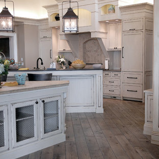 Huge coastal eat-in kitchen ideas - Inspiration for a huge coastal u-shaped medium tone wood floor, brown floor and vaulted ceiling eat-in kitchen remodel in Chicago with an undermount sink, beaded inset cabinets, white cabinets, granite countertops, multicolored backsplash, ceramic backsplash, two islands and black countertops