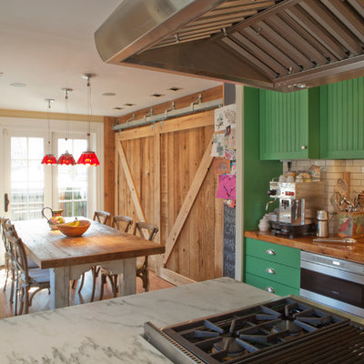 Inspiration for a timeless eat-in kitchen remodel in Philadelphia with subway tile backsplash, wood countertops, green cabinets and stainless steel appliances