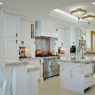 Victorian u-shaped open plan kitchen in Miami with recessed-panel cabinets, white cabinets, beige splashback, stone slab splashback, with island, beige floor and beige benchtop.