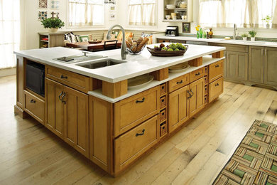Inspiration for a large transitional u-shaped light wood floor eat-in kitchen remodel in Sacramento with an undermount sink, shaker cabinets, distressed cabinets, solid surface countertops, stainless steel appliances and an island