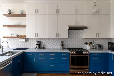 Mid-sized trendy u-shaped dark wood floor and brown floor kitchen photo in San Francisco with a single-bowl sink, flat-panel cabinets, blue cabinets, white backsplash, stainless steel appliances, no island and white countertops