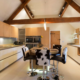 This is an example of a large rustic u-shaped kitchen in West Midlands with flat-panel cabinets, white cabinets, wood worktops, an island, beige floors, blue splashback and beige worktops.