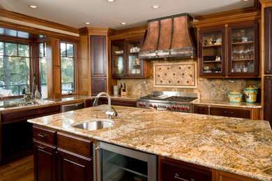 Mid-sized tuscan u-shaped dark wood floor kitchen photo in Other with an undermount sink, raised-panel cabinets, dark wood cabinets, marble countertops, stone slab backsplash, stainless steel appliances and an island