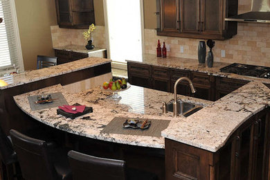 Example of a mid-sized trendy u-shaped kitchen design in Calgary with an island and beige backsplash
