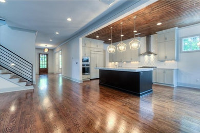 Inspiration for a mid-sized contemporary l-shaped dark wood floor open concept kitchen remodel in Atlanta with shaker cabinets, an island, gray cabinets, quartz countertops, white backsplash, porcelain backsplash and stainless steel appliances