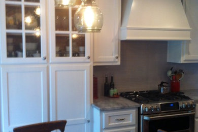 Example of an eat-in kitchen design in Dallas with recessed-panel cabinets, white cabinets and stainless steel appliances
