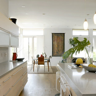 Large contemporary eat-in kitchen remodeling - Inspiration for a large contemporary u-shaped light wood floor eat-in kitchen remodel in Los Angeles with an undermount sink, flat-panel cabinets, light wood cabinets, quartz countertops, gray backsplash, porcelain backsplash, an island and stainless steel appliances