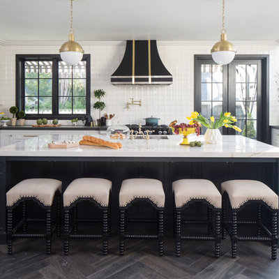 Inspiration for a transitional u-shaped dark wood floor and brown floor eat-in kitchen remodel in Los Angeles with an undermount sink, shaker cabinets, white cabinets, white backsplash, ceramic backsplash, stainless steel appliances and an island