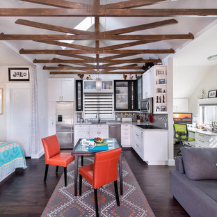 Transitional open concept kitchen ideas - Example of a transitional l-shaped dark wood floor open concept kitchen design in Denver with recessed-panel cabinets, white cabinets, granite countertops, stainless steel appliances, no island, an undermount sink and multicolored backsplash