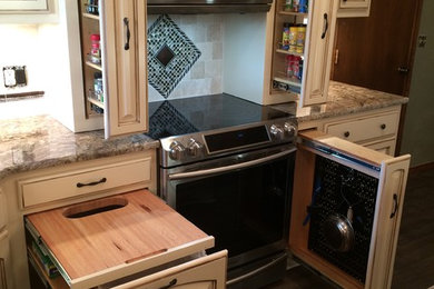 Example of a large classic u-shaped medium tone wood floor eat-in kitchen design in Oklahoma City with a double-bowl sink, raised-panel cabinets, distressed cabinets, granite countertops, multicolored backsplash, ceramic backsplash, stainless steel appliances and an island