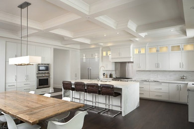 Open concept kitchen - large contemporary u-shaped medium tone wood floor open concept kitchen idea in Toronto with an undermount sink, flat-panel cabinets, white cabinets, marble countertops, white backsplash, stone tile backsplash, stainless steel appliances and an island