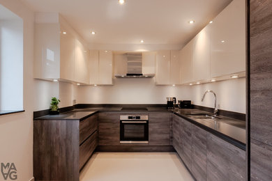 Inspiration for a large contemporary u-shaped kitchen/diner in London with a double-bowl sink, flat-panel cabinets, medium wood cabinets, quartz worktops, white splashback, integrated appliances, porcelain flooring and no island.