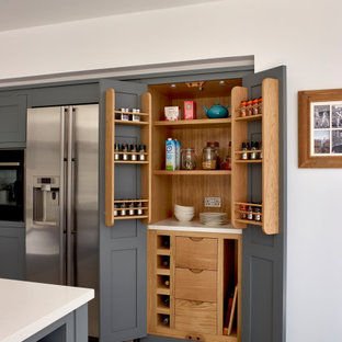 This is an example of a medium sized classic kitchen in Surrey with shaker cabinets, grey cabinets, stainless steel appliances and grey floors.