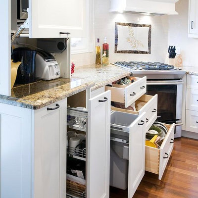 Example of a transitional kitchen design in Toronto with recessed-panel cabinets, white cabinets, white backsplash and stainless steel appliances