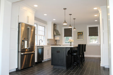Example of a mid-sized transitional galley porcelain tile eat-in kitchen design in Other with shaker cabinets, white cabinets, quartz countertops, glass tile backsplash, stainless steel appliances and an island