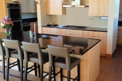 Example of a huge minimalist u-shaped porcelain tile eat-in kitchen design in Minneapolis with an undermount sink, light wood cabinets, quartzite countertops, multicolored backsplash, an island, flat-panel cabinets and stainless steel appliances