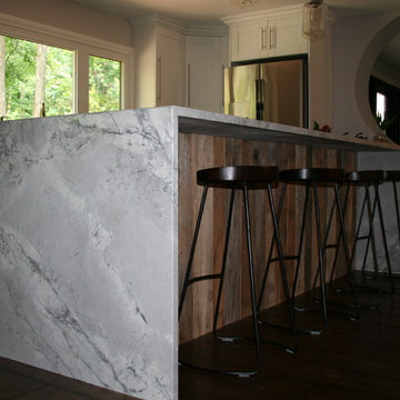 Quartz waterfall island countertop accented with barnboard