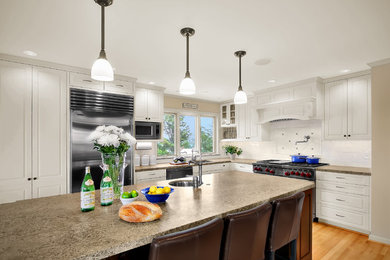 Example of a classic l-shaped kitchen design in Seattle with granite countertops and stainless steel appliances