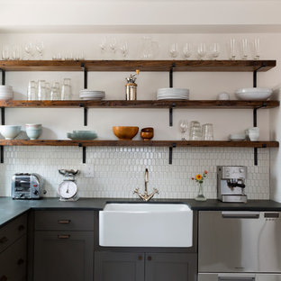Inspiration for a mid-sized contemporary l-shaped eat-in kitchen in Philadelphia with a farmhouse sink, grey cabinets, white splashback, ceramic splashback, stainless steel appliances, porcelain floors, no island, multi-coloured floor, shaker cabinets and grey benchtop.