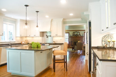 Large transitional l-shaped medium tone wood floor eat-in kitchen photo in Richmond with a farmhouse sink, flat-panel cabinets, white cabinets, quartz countertops, white backsplash, paneled appliances and an island