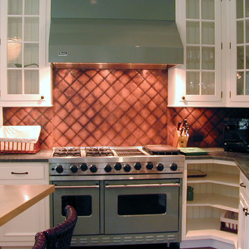 Quilted, patinated copper backsplash by Brooks Custom