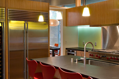 Photo of a contemporary kitchen in San Francisco with a submerged sink, flat-panel cabinets, medium wood cabinets, stainless steel appliances and an island.