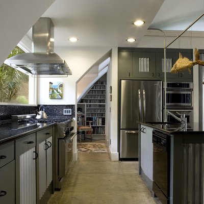 Inspiration for a mid-sized industrial galley concrete floor eat-in kitchen remodel in Atlanta with stainless steel appliances, an undermount sink, granite countertops, black backsplash, glass tile backsplash, an island and gray cabinets