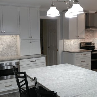 Large contemporary eat-in kitchen pictures - Example of a large trendy galley vinyl floor and gray floor eat-in kitchen design in Tampa with an undermount sink, recessed-panel cabinets, white cabinets, granite countertops, white backsplash, marble backsplash, stainless steel appliances, an island and white countertops