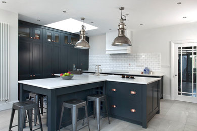 Photo of a traditional kitchen in Other with a built-in sink, shaker cabinets, blue cabinets, quartz worktops, white splashback, ceramic splashback, stainless steel appliances, ceramic flooring and an island.