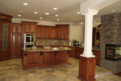 Large elegant u-shaped terra-cotta tile and beige floor eat-in kitchen photo in Other with an undermount sink, dark wood cabinets, granite countertops, multicolored backsplash, stone tile backsplash, stainless steel appliances, an island and raised-panel cabinets