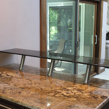 Raised glass counter attached to a granite countertop