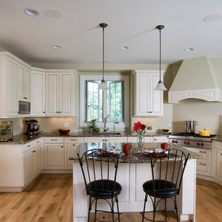 Large traditional open concept kitchen designs - Open concept kitchen - large traditional u-shaped light wood floor open concept kitchen idea in Chicago with an undermount sink, raised-panel cabinets, white cabinets, granite countertops, paneled appliances and an island