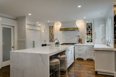 Example of a transitional medium tone wood floor kitchen design in Raleigh with beaded inset cabinets, white cabinets, marble countertops, multicolored backsplash, stone slab backsplash, paneled appliances and an island