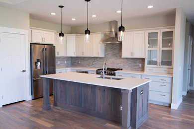 Mid-sized transitional l-shaped medium tone wood floor and beige floor kitchen pantry photo in Other with an undermount sink, shaker cabinets, gray cabinets, quartz countertops, gray backsplash, porcelain backsplash, stainless steel appliances and an island