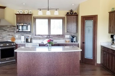 Classic u-shaped kitchen in Other with stainless steel appliances and an island.
