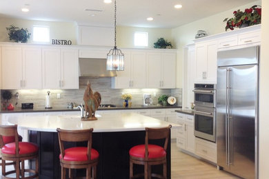 Large transitional l-shaped porcelain tile and beige floor kitchen photo in Orange County with an undermount sink, shaker cabinets, white cabinets, quartz countertops, gray backsplash, matchstick tile backsplash, stainless steel appliances and an island