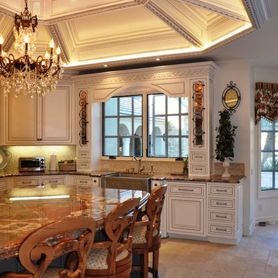 Example of a large classic u-shaped ceramic tile and beige floor open concept kitchen design in San Diego with marble countertops, a farmhouse sink, beaded inset cabinets, beige cabinets, beige backsplash, mosaic tile backsplash, stainless steel appliances and an island