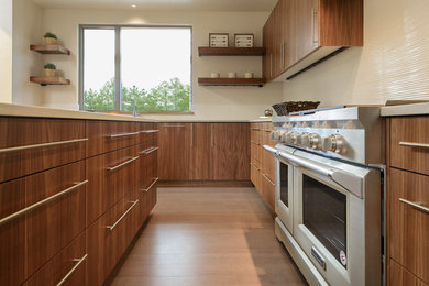 Example of a mid-sized trendy u-shaped bamboo floor open concept kitchen design in Other with a single-bowl sink, flat-panel cabinets, dark wood cabinets, quartz countertops, white backsplash, cement tile backsplash, stainless steel appliances and an island