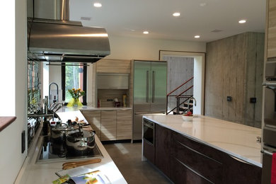 Eat-in kitchen - large contemporary l-shaped concrete floor eat-in kitchen idea in New York with an undermount sink, granite countertops, ceramic backsplash, stainless steel appliances and an island
