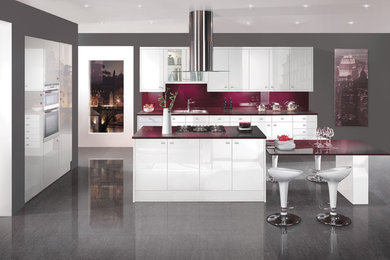 Design ideas for a contemporary kitchen in Other with flat-panel cabinets, white cabinets, laminate countertops, black splashback, integrated appliances and an island.