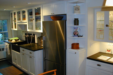 Large transitional galley enclosed kitchen photo in Other with white cabinets, stainless steel appliances, an island, a farmhouse sink, shaker cabinets, soapstone countertops, white backsplash and subway tile backsplash