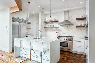 Example of a mid-sized minimalist l-shaped medium tone wood floor and brown floor eat-in kitchen design in Vancouver with a double-bowl sink, flat-panel cabinets, white cabinets, quartz countertops, white backsplash, porcelain backsplash, stainless steel appliances, an island and white countertops