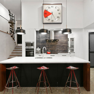 Inspiration for an industrial kitchen in Other with an undermount sink, white cabinets, brown splashback, stainless steel appliances, with island, beige floor, white benchtop and concrete floors.