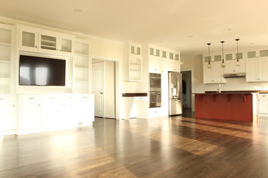 ワシントンD.C.にあるおしゃれなアイランドキッチン (シェーカースタイル扉のキャビネット、白いキャビネット、シルバーの調理設備、無垢フローリング) の写真