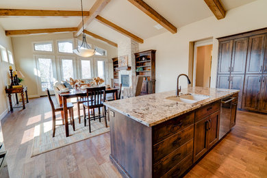 Eat-in kitchen - large traditional l-shaped dark wood floor and brown floor eat-in kitchen idea in Boise with granite countertops, an undermount sink, shaker cabinets, dark wood cabinets, beige backsplash, stone tile backsplash, stainless steel appliances and an island