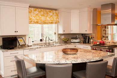 Transitional l-shaped medium tone wood floor eat-in kitchen photo in Baltimore with an undermount sink, recessed-panel cabinets, white cabinets, granite countertops, glass tile backsplash, stainless steel appliances and an island