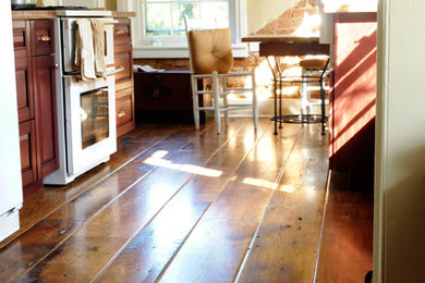 Eat-in kitchen - mid-sized farmhouse medium tone wood floor and brown floor eat-in kitchen idea in Other